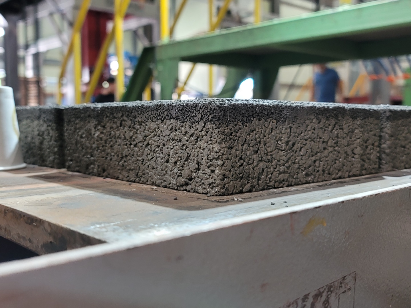 Close up corner of an SPP Block showing reclaimed aggregate and spent coffee grounds in the finished mix